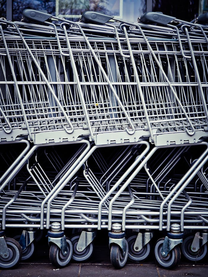 Rows of stacked metal shopping carts forming a repetitive industrial pattern.